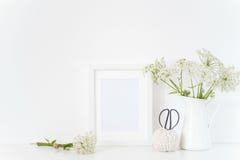 White frame mock up with a Aegopodium in jug, bouquet. Mockup for design. Template for lifestyle bloggers, social media