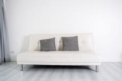White Leather Sofa Bed On White Room. Stock Photo