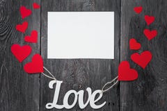 White letters Love with ropes and with red hearts, like balloons. space for text on a white sheet of paper