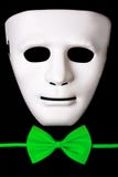 White mask and green bow tie