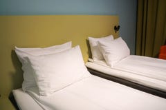 White mattress and comfortable pillows in hotel twin bedroom stock photo White mattress and comfortable pillows in hotel twin bedroom stock photo