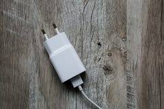 White mobile phone charger on wooden background. Smartphone char stock images White mobile phone charger on wooden background. Smartphone char stock images