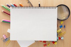 White paper notebook with office supplies on wooden background. Stock Images White paper notebook with office supplies on wooden background. Stock Images