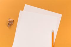 White paper sheets with pencil on orange desk royalty free stock photography White paper sheets with pencil on orange desk royalty free stock photography