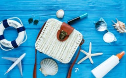 White rattan bag on blue background. Bamboo trendy bag, starfish, shells. Summer fashion flat lay, tourism, vacation, travel stock photos White rattan bag on blue background. Bamboo trendy bag, starfish, shells. Summer fashion flat lay, tourism, vacation, travel stock photos