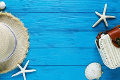 White rattan bag, straw hat on blue background. bamboo trendy bag, starfish, shells. Summer fashion flat lay, vacation, travel stock image White rattan bag, straw hat on blue background. bamboo trendy bag, starfish, shells. Summer fashion flat lay, vacation, travel stock image