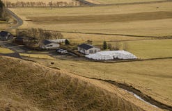 Traditional farming in Iceland. White round bales with grass lying near a farm on a dry yellow grass in Iceland stock photo Traditional farming in Iceland. White round bales with grass lying near a farm on a dry yellow grass in Iceland stock photo