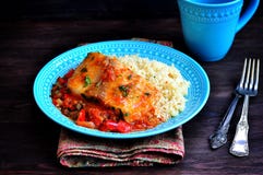 White Sea Fish Cooked In A Spicy Tomato Sauce With Sweet Pepper, Cumin, Garlic And Coriander. Stock Photography