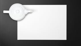 White tea pot on white paper on black background stock photo White tea pot on white paper on black background stock photo