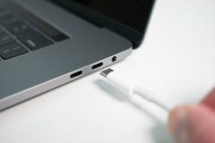 A white USB type C / USB-C cable being plugged into a modern notebook / laptop computer stock photography A white USB type C / USB-C cable being plugged into a modern notebook / laptop computer stock photography