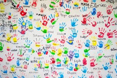 White wall with colorful imprints of children hands. stock images White wall with colorful imprints of children hands. stock images