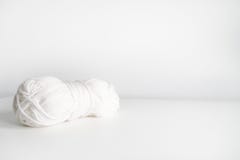 White yarn. Skein of wool boho logo. Space for text stock photography White yarn. Skein of wool boho logo. Space for text stock photography