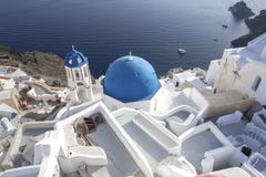 Whitewashed houses and blue dome church by the Aegean sea, Santoriniin Oia, Santorini, Greece. Famous blue domes in Oia village, royalty free stock photography Whitewashed houses and blue dome church by the Aegean sea, Santoriniin Oia, Santorini, Greece. Famous blue domes in Oia village, royalty free stock photography