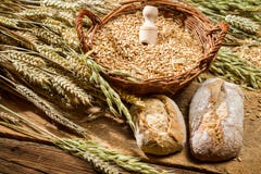 Whole grains buns and a basket with cereals royalty free stock photography Whole grains buns and a basket with cereals royalty free stock photography