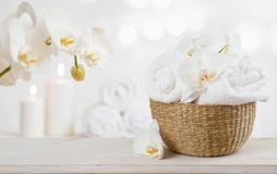 Wicker Basket With Spa Towels On Table Over Abstract Background Stock Photos Wicker Basket With Spa Towels On Table Over Abstract Background Stock Photos