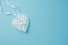 Wicker White Decorative Heart on Light Blue Background Corner Position. Valentine Mother`s Day Romantic stock images Wicker White Decorative Heart on Light Blue Background Corner Position. Valentine Mother`s Day Romantic stock images
