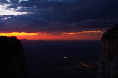 Wide angle view of sunset at Tunda Vala cliff and city lights below stock photos Wide angle view of sunset at Tunda Vala cliff and city lights below stock photos