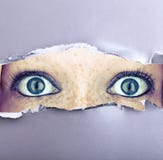 Wide Open Eyes In A Wall Stock Photos