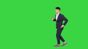 Cool man in formal outfit walking and dancing on a Green Screen, Chroma Key.