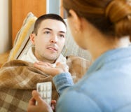 Wife giving pills to diseased man royalty free stock photo Wife giving pills to diseased man royalty free stock photo