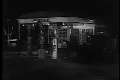 Wijd geschotene ot jaren '30auto die benzinestation ingaan bij nacht stock video Wijd geschotene ot jaren '30auto die benzinestation ingaan bij nacht stock video