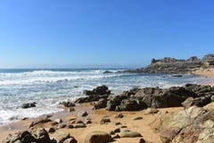 Wild beach with golden sand, furious sea, waves and prehistoric settlement ruins. Barona, Galicia, Spain. Sunny day, blue sky. stock image Wild beach with golden sand, furious sea, waves and prehistoric settlement ruins. Barona, Galicia, Spain. Sunny day, blue sky. stock image