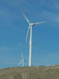 Wind farm: Industrial Eolic installation . Wind turbines towers again cloud blue sky on a wind farm sustainable, renewable energy royalty free stock photos Wind farm: Industrial Eolic installation . Wind turbines towers again cloud blue sky on a wind farm sustainable, renewable energy royalty free stock photos