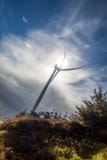 Wind turbine against blue skies. Wind turbine on hillside against blue skies with white clouds Stock Photography Wind turbine against blue skies. Wind turbine on hillside against blue skies with white clouds Stock Photography
