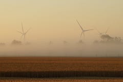 Wind turbine on a field at a foggy morning royalty free stock photos Wind turbine on a field at a foggy morning royalty free stock photos