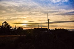 Wind turbines on the hill of a mountain in a beautiful sunset royalty free stock image Wind turbines on the hill of a mountain in a beautiful sunset royalty free stock image