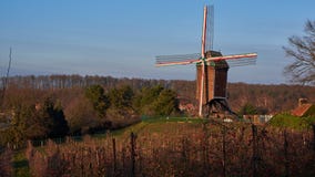 Windmill among apple trees stock photos Windmill among apple trees stock photos