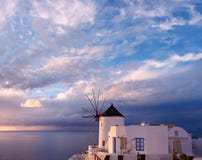 Windmill in Oia village on Santorini island, Greece, at sunset Royalty Free Stock Photo Windmill in Oia village on Santorini island, Greece, at sunset Royalty Free Stock Photo