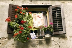 Window With Flowers And Laundry Stock Photo
