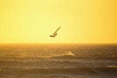Windsurfing high jump at sunset