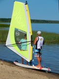 A windsurfing lesson with an instructor on Plescheevo lake near the town of Pereslavl-Zalessky in Russia.