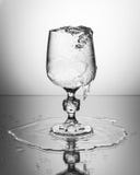 Wine glass with sparkling water. Clear wine glass with sparkling water splashing out Stock Image Wine glass with sparkling water. Clear wine glass with sparkling water splashing out Stock Image