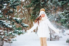 Winter close up portrait of cute dreamy child girl in white coat, hat and mittens stock images Winter close up portrait of cute dreamy child girl in white coat, hat and mittens stock images