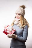 Winter portrait of a beautiful young woman in warm knitted clothes and with a gift on her hands stock photo Winter portrait of a beautiful young woman in warm knitted clothes and with a gift on her hands stock photo