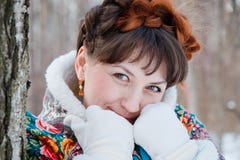 Winter portreit of girl with beautiful hair on her head in Russian folk style in blue shawls royalty free stock photography Winter portreit of girl with beautiful hair on her head in Russian folk style in blue shawls royalty free stock photography