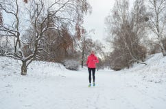 winter running park happy active woman runner jogging snow outdoor sport fitness winter running park happy active 104262889-BMH