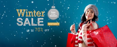 Winter sale message with woman holding shopping bags stock image Winter sale message with woman holding shopping bags stock image
