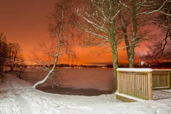 Winter scenery with frozen lake at night stock photo Winter scenery with frozen lake at night stock photo