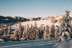 Sunny winter morning in polish Tatra mountains. Mountain hill village with wooden cottages stock photography Sunny winter morning in polish Tatra mountains. Mountain hill village with wooden cottages stock photography