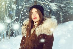 Winter woman in snow looking at camera outside on snowing cold winter day. Portrait Caucasian female model outside in first snow royalty free stock images Winter woman in snow looking at camera outside on snowing cold winter day. Portrait Caucasian female model outside in first snow royalty free stock images