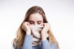 Winterporträt von schönen Blondinen in der Strickjacke und im Schal auf einem weißen Hintergrund Mädchen bedeckt ihr Gesicht mit lizenzfreies stockbild Winterporträt von schönen Blondinen in der Strickjacke und im Schal auf einem weißen Hintergrund Mädchen bedeckt ihr Gesicht mit lizenzfreies stockbild