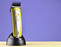 Wireless clipper with a nozzle stands on a charging station royalty free stock photo Wireless clipper with a nozzle stands on a charging station royalty free stock photo