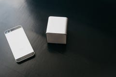 Wireless speakers and a cell phone next to them on a dark background. Modern technology for listening to music from a royalty free stock photo Wireless speakers and a cell phone next to them on a dark background. Modern technology for listening to music from a royalty free stock photo
