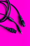 Wires for charging on pink background top view stock image Wires for charging on pink background top view stock image
