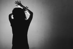 Woman afraid of something, covering face and head with light beh stock images Woman afraid of something, covering face and head with light beh stock images