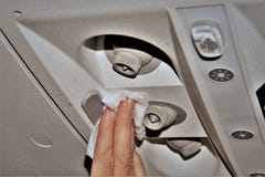 A woman in an airplane cleaning the air vents stock photography A woman in an airplane cleaning the air vents stock photography